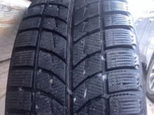 Closer view of tire tread depth and pattern.
