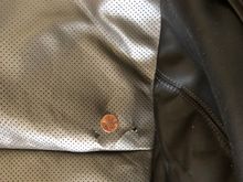 This is the area of the cushion cover which has a tear.  The penny is for perspective