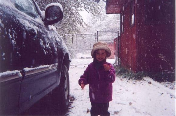 My daughter Abigal showing me a snow flake she caught. This was taken 9-25-2004 and was our first snowfall for the winter, 6 inches fell that day.