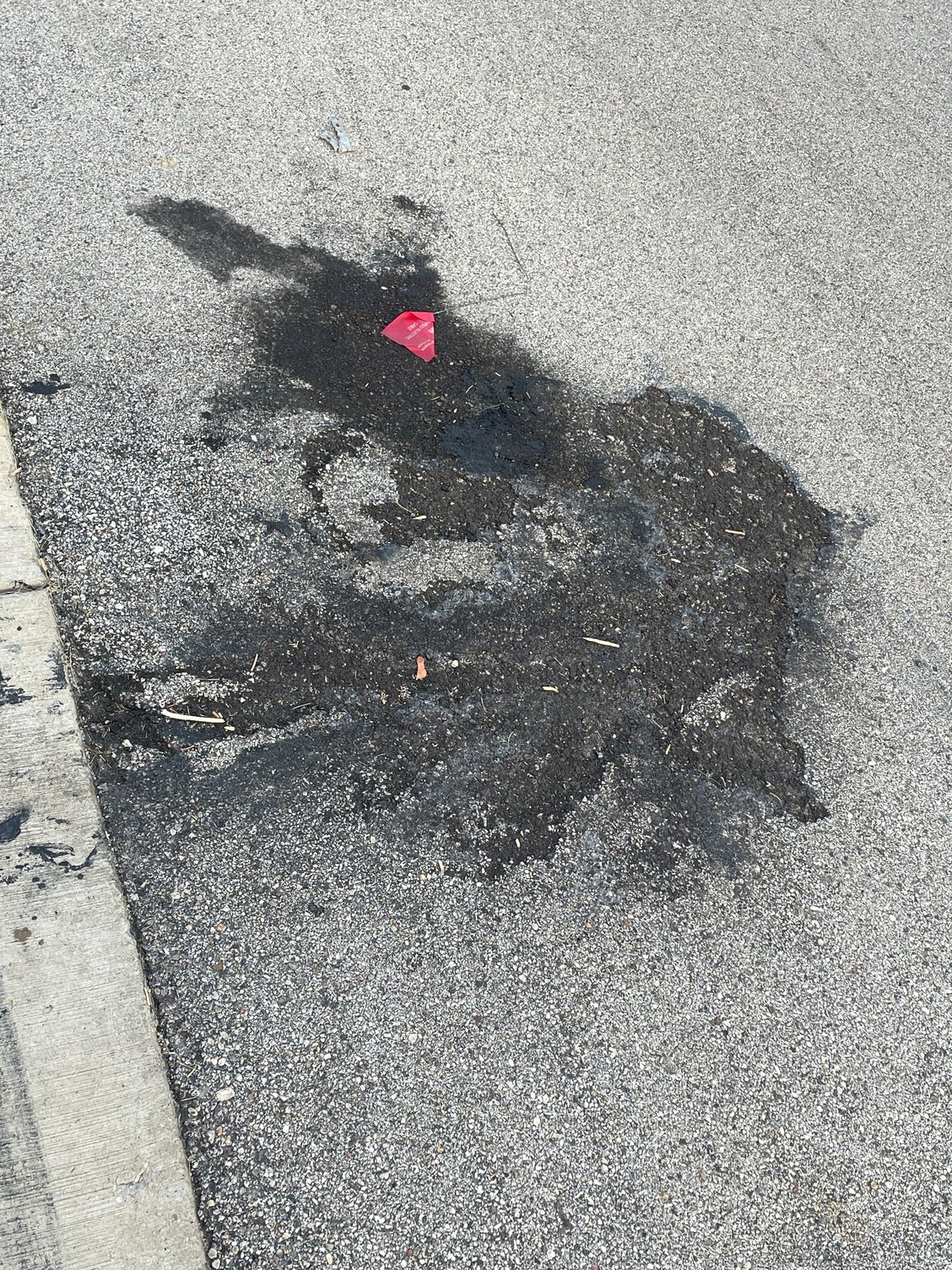 This is a burnt spot on the street. I watched a Camaro burn down here a month or two back. It was really sad. The guy was there watching his baby burn while he awaited the fire department. You can see it actually burned INTO the asphalt. 