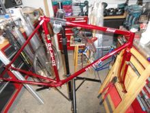 Sorry for the indoor clutter but the weather outside is a bit wet.  Frame & fork size 55cm  CTT.   dropout adjusters are new SS. and binder is a Raleigh branded model.   Color is a deep prizmatic cranberry.