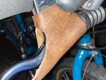 Definitely leather, not sue if custom or over the counter.  They are on Italian made Tommaselli levers.  