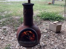 Baby Chiminea burning small pieces of wood great for when I’m smoking food. Real time photo. Yes I am that bored lol. 