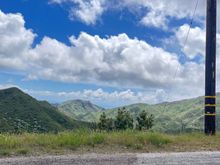 A view looking west from the ridge of the Santa Monica Mountains, with a sliver of the Pacific in the distance.