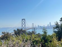 .A panoramic view, left to right: Bay Bridge, San Francisco. Viewpoint with an odd spire, Alcatraz Island, Treasure Island flats.