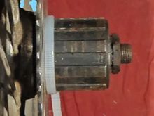 Sprocket placed against cassette body seat.  Lollipop and arrow same as previous photo.  Note large space between sprocket and spokes...