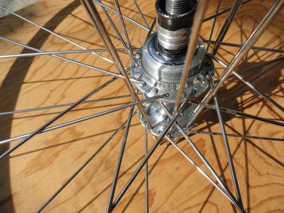 By placing the spokes through the star pattern closest to the hub flange they will drop through a bit easier.