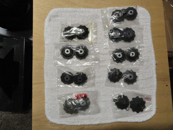 I think the set on the lower right is Shimano.   The sets are complete with bronze bearings and washers.  
