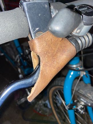 Definitely leather, not sue if custom or over the counter.  They are on Italian made Tommaselli levers.  
