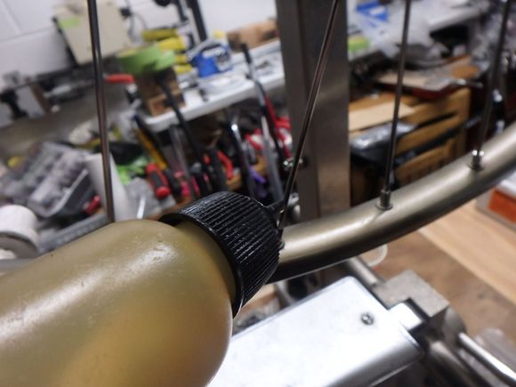 A single drop of oil on each spoke nipple to aid in the process.