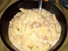 Bacon and steak in some creamy Alfredo sauce and noodles
