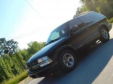 The front of my truck on the road.