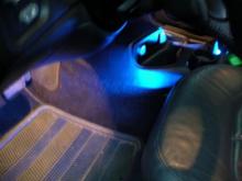blue under led strips from harbor freight just tucked into toe gap between the seat and the seat frame
