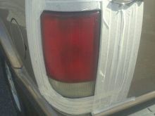 putting up the tape to tint the tail lamps