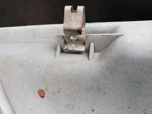 Once of the clips that holds the gill in place. I found pushing on the little tab in the middle of the main tab made it easy to remove these from the metal radiator frame.