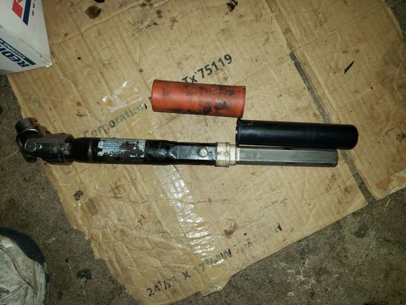 Lower intermediate shaft with the orange rubber sleeve and the upper black plastic sleeve.