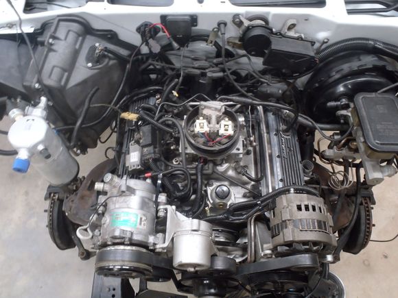 Notice the ground stud next to the thermostat housing and the support rod for the AC bracket. No ground strap on the passenger side cylinder head. Moved to the face of the block.  