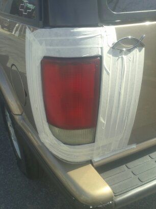 putting up the tape to tint the tail lamps