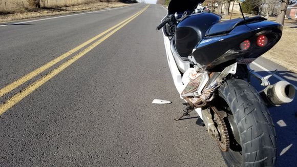 Bag in swingarm... Passed some buses a little fast and my crappy tailbag  i rigged up didn't stand a chance...then my tire didn't stand a chance. Me and 2 other nice pedestrians helped me get that out of my swingarm.
