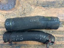 Original stamped rubber gas lines with different stamps and fonts.