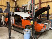 Top slid forward and rear lifted up to get tack strip bow clear of body.