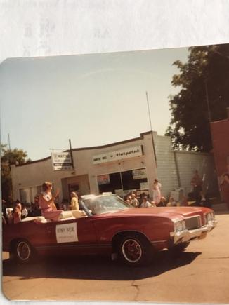 At the Sunflower Festival parade in Altona, Manitoba, carrying a contestant for Sunflower Queen in the late '70s.