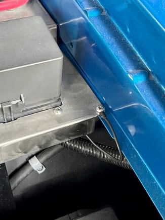 This self-tapping screw ties the front of the bas plat to the fender. The little black wire is the ground path for the relay coils in the auxillary fuse block.