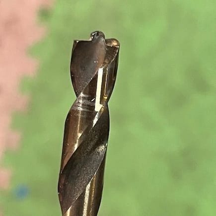 I drilled out the spot welds with this special drill bit that has a small pilot point and a flat profile where a regular drill bit has a 60-degree point.  This bit allows you to drill only deep enough to separate the 2 panels.