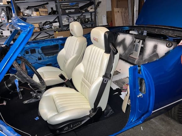 The BMW M3 bucket seats covered in Pearl White vinyl.