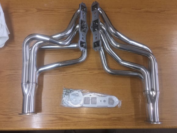 The passenger side header is about 4" shorter than the other.  Shortest pipe to collector exit is 28" longest is 39".  Comes with the foil covered paper gaskets and some really long bolts you could use on another project.