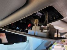 Unsnapped overhead console.  Pull down from the rear, then unhook from the front.
