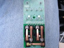 The contact I cleaned is the far right one at the bottom.  Be sure to also gently clean the pad as well or else it will just get corroded again.  Be sure to gently clean all this using rubbing alcohol.  I also had to use a fine scraper and magnifying lense because of especially tough corrosion.  All in all the whole thing too me about 30 minutes to complete.