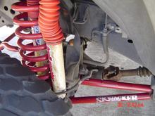 RED PAINTED SKYJACKER SUSPENSION WITH DUPLICOLOR BRAKE CALIPER BRUSH ON PAINT.