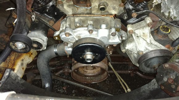 Timing cover, damper, and water pump are all back on.