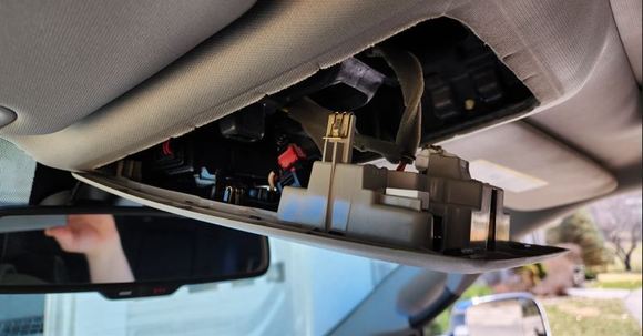 Unsnapped overhead console. Pull down from the rear, then unhook from the front.