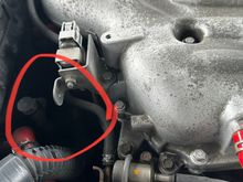It’s located under this hose behind the engine.
