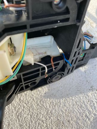 Micro switch has been removed. When the shift is depressed, it makes contact with the micro switch. The micro switch releases the shift lever from Park.