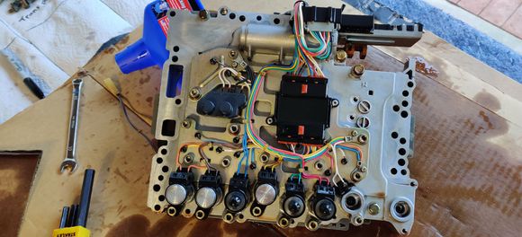 This shows 6 of the 7 solenoids on the valve body along the bottom. I had already removed the Low coast brake solenoid on the far right side. Each one is held in with an allen key