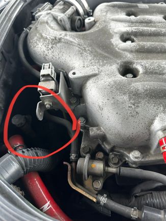It’s located under this hose behind the engine.