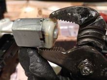 Uses small cramp or adjustable wrench to remove the rubber cap.  You need to squeeze the rubber cap to deform a little in order to remove it