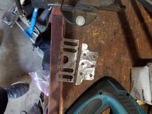 Ground all the paint off, and cut it in half, saving the part with the slots that we needed.