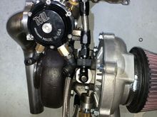 Look!!! I water cooled the wastegate. That’s why I had that note book with the ghetto angles, and this is what else the 6AN weld bung on the water pipe is feeding. Well the bung has a hose that goes to a T on one side of the turbo.. there is a T on the other side too. Took some thinking to figure out the fittings and adapters and such. Costed around 115 to make this damn wastegate watercooler, totally  unnecessary but totally cool! 