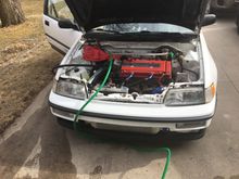 Garden hose hooked up and the black heater hose outlet onto driveway