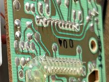 Cracks on the 4th and 5th solder joints from the left above the long line of solder joints in the middle