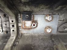 Plate sandwiching the body. Mounting tab welded to it.