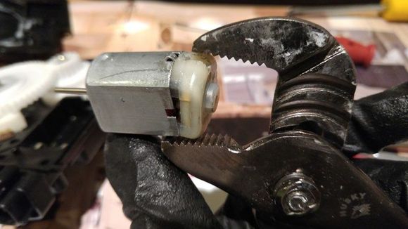 Uses small cramp or adjustable wrench to remove the rubber cap.  You need to squeeze the rubber cap to deform a little in order to remove it