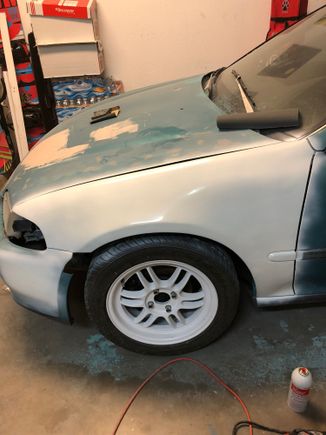 Test painted the fender. Rattle can white. I think this will do. Also note the piece MIA off the bumper. This will stay. I can always paint a replacement easily. 
Only concern with the “spray bomb” is the lack of UV longevity. But I can’t pass up a $20 paint job. And this thing will be garaged most of the time with my primary vehicle. Perks of a company daily! Going to need to re sand a few areas and lay high build primer. But this will work for a while.