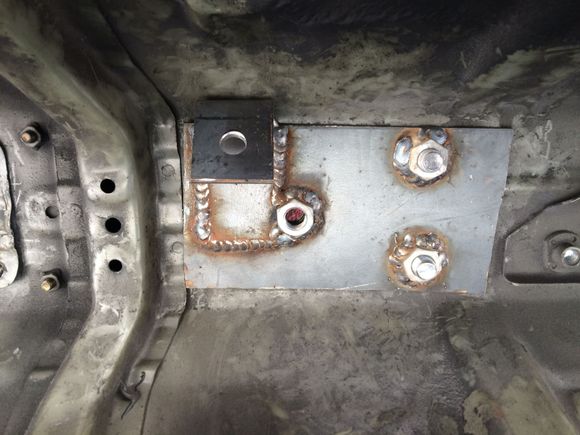 Plate sandwiching the body. Mounting tab welded to it.