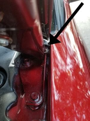 Where the hose is currently popping out between the hood and the car body. Where should the hose actually come up from the washer container?