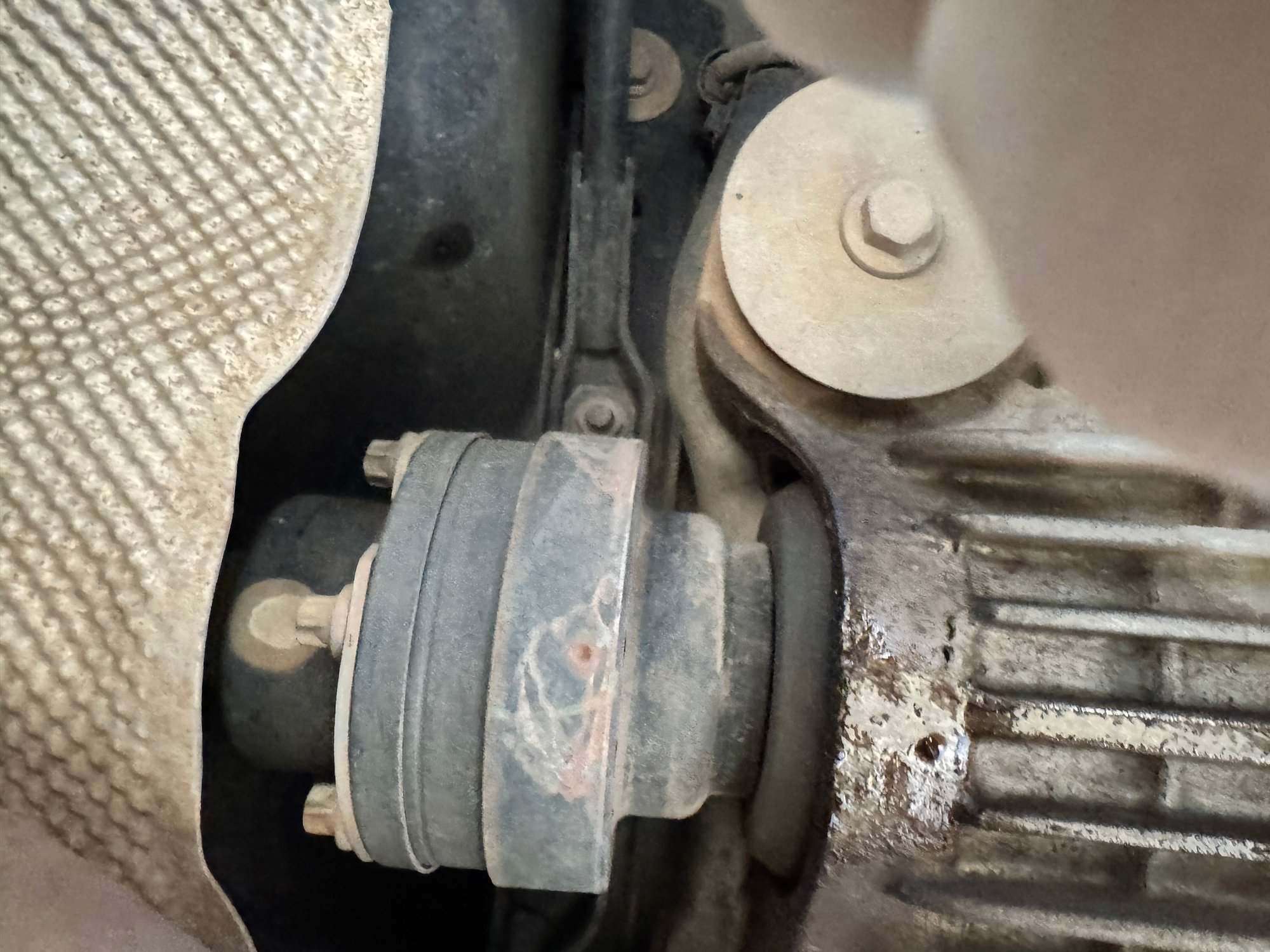 That’s the driveshaft going towards front of car on the left there.  leaking out the seal around the driveshaft, down, and then moving back with wind I guess... 